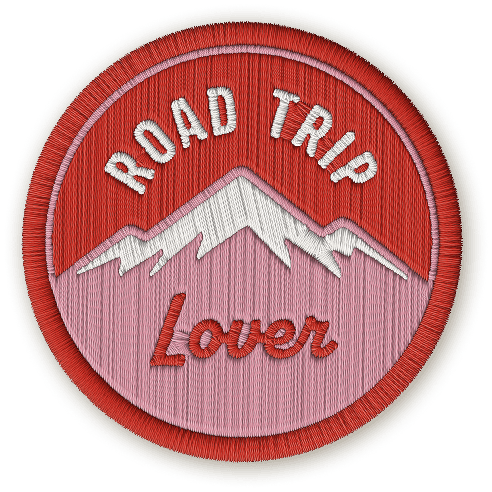 The Road Trip Lover badge depicting a red snow-capped mountain