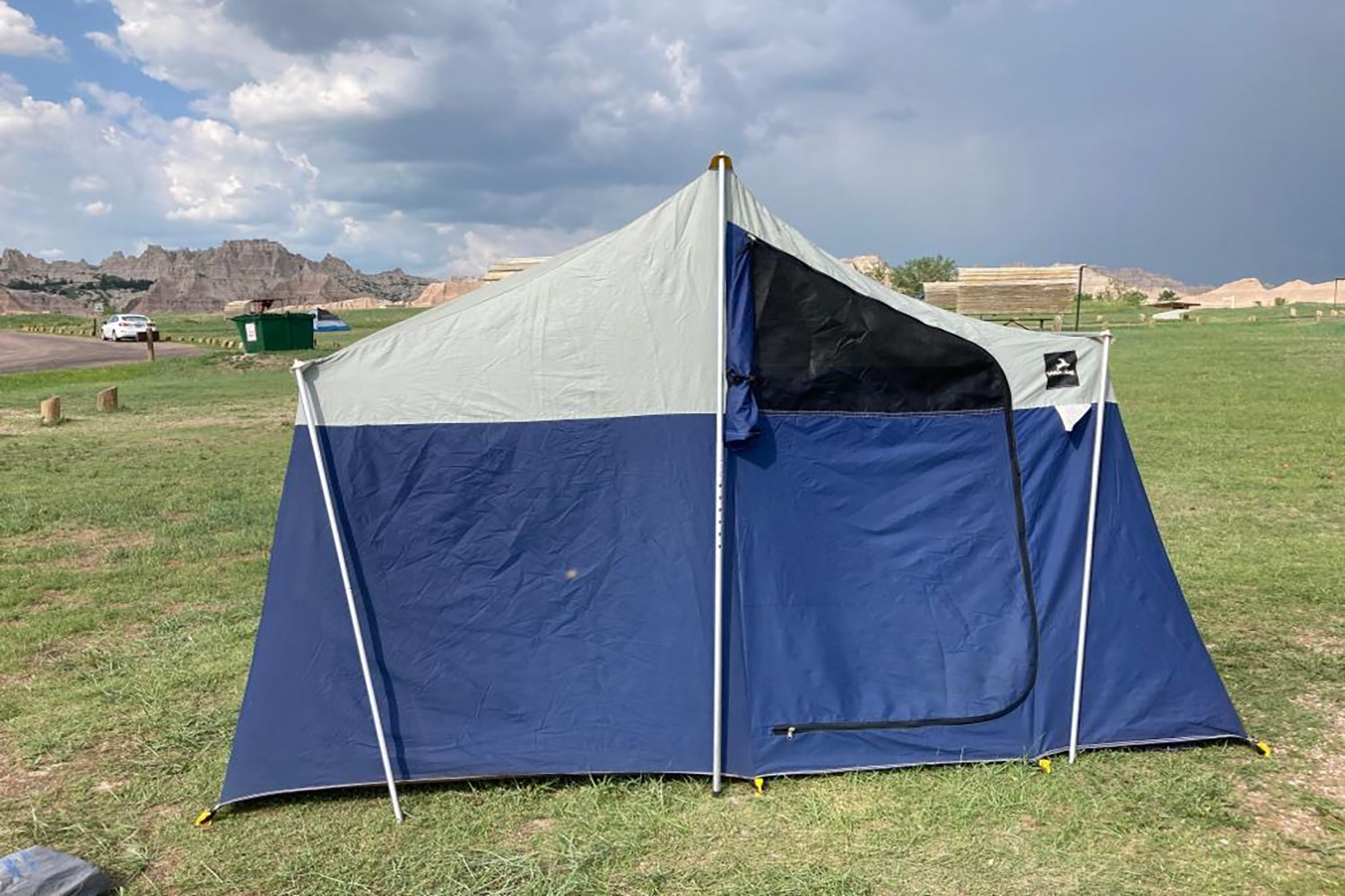 A blue and white tent set up at a campground at the Badlands National Park.