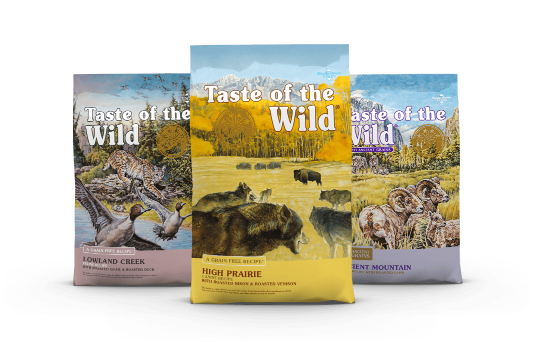 A bag of Taste of the Wild High Prairie in front of a bag of Taste of the Wild Lowland Creek and a bag of Taste of the Wild Ancient Mountain