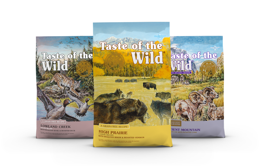 A bag of Taste of the Wild High Prairie in front of a bag of Taste of the Wild Lowland Creek and a bag of Taste of the Wild Ancient Mountain