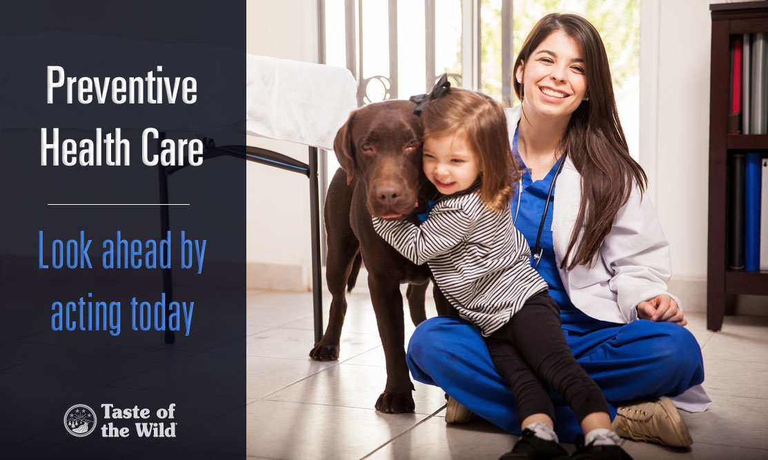 A veterinarian and a child with a brown dog